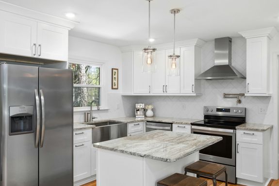 White Kitchen Interior with Metallic Fridge