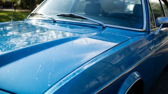 Photo of Man Cleaning His Car