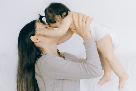 A Woman Carrying Her Baby 