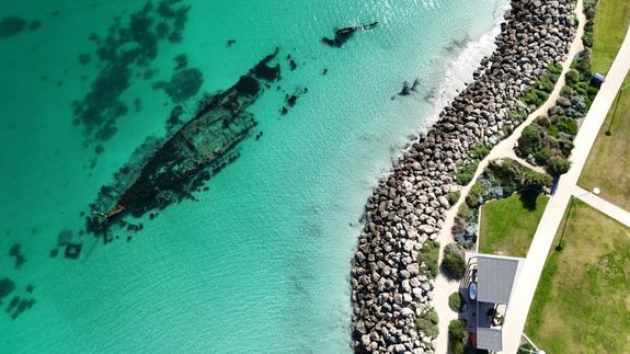 Aerial view of the ocean and rocks near a beach