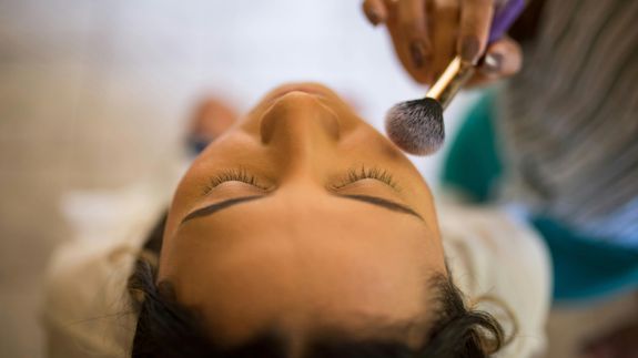 Beautician Putting Make Up on a Customer Face
