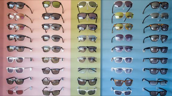 From above of fashion glasses with optical lenses for vision correction in metal shells together with pair in plastic tortoise shell placed on white table