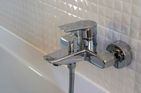 Stainless Steel Faucet on White Ceramic Sink