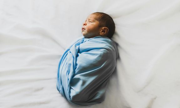 Photo Of New Born Baby Covered With Blue Blanket