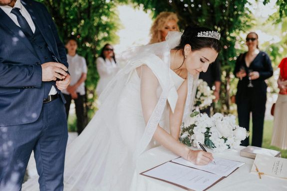 A bride signing her wedding vows at a ceremony
