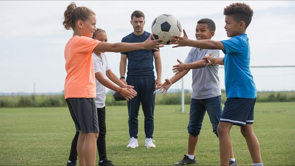 group of people playing soccer on soccer field