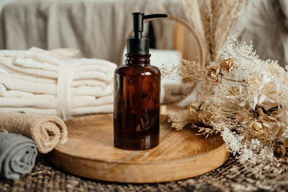 Brown Pump Bottle on Brown Wooden Plate