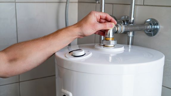 Ceramic bidet and shower cabin in contemporary bathroom