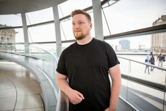 A Male Wearing a T-shirt and Looking Away 