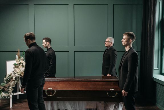 Men Standing Near the Coffin