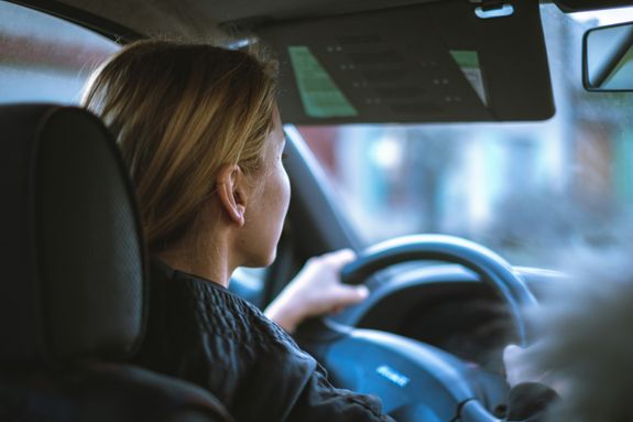 Ethnic man driving taxi equipped with navigator