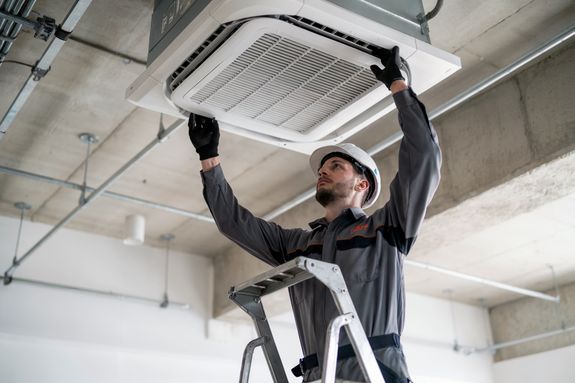 A building with a green roof and a white wall