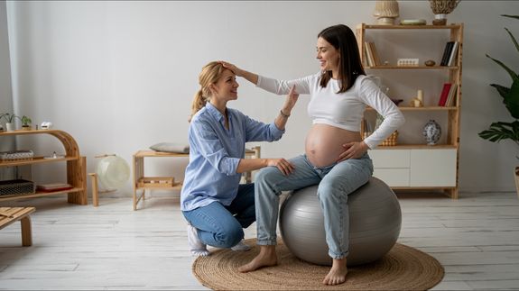 Pregnant Woman Wearing Beige Long Sleeve Shirt Standing Near Brown Tree at Daytime