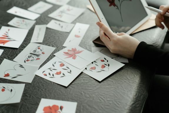 Person Holding 6 of Diamonds Playing Cards