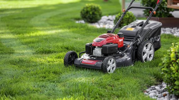 A Person Mowing the Lawn 