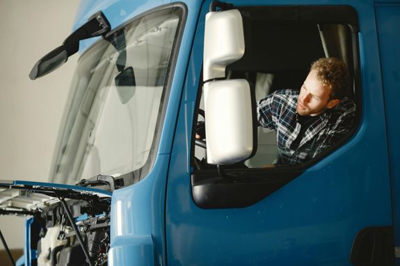 A Man Riding a Blue Truck