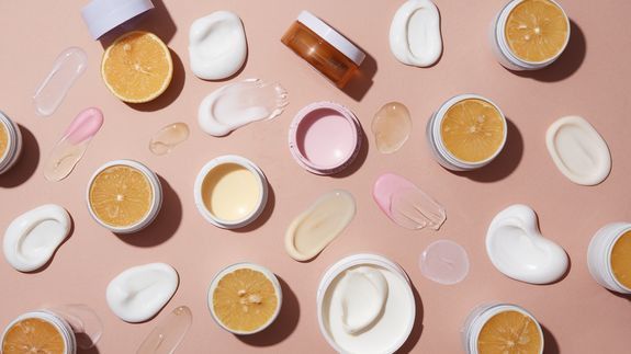 Modern leather chairs with backwash sinks placed in modern spacious beauty salon with windows and various professional supplies under glowing lamps