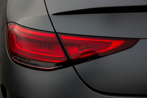 Close-up of a sleek and elegant modern car taillight with glowing red detail.