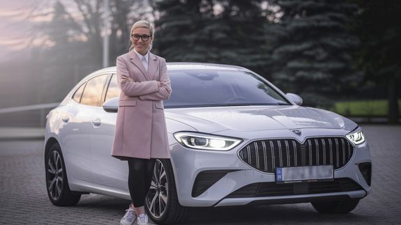Serious Asian woman driving right hand car