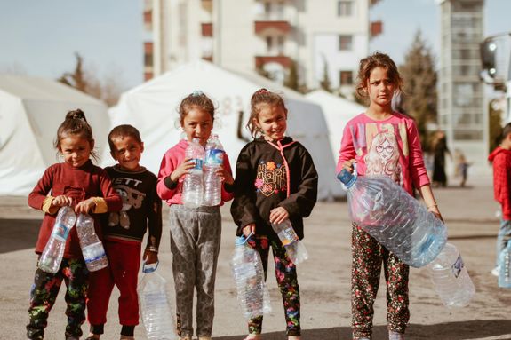 Children with Empty Plastic Bottles