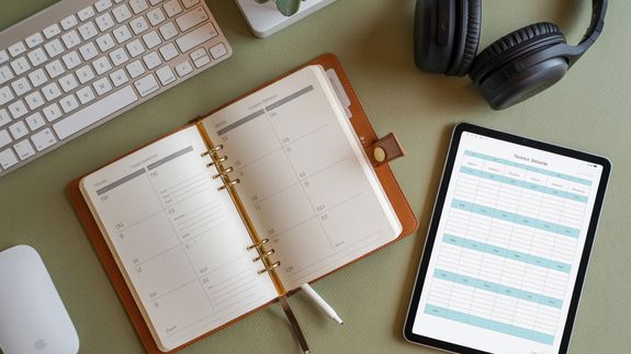 Woman Sitting at the Desk with an iPhone in her Hands 