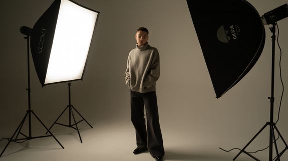 Selective Focus Photography of Black Canon Camera Displaying Photo of Red and Black Building