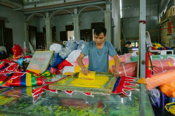 A man is working on a table with colorful items