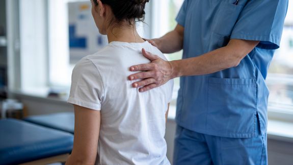 Chiropractor with Model of Spine