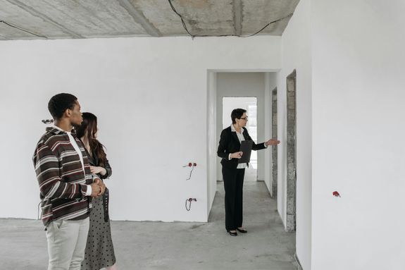 Couple and Real Estate Agent Exploring House