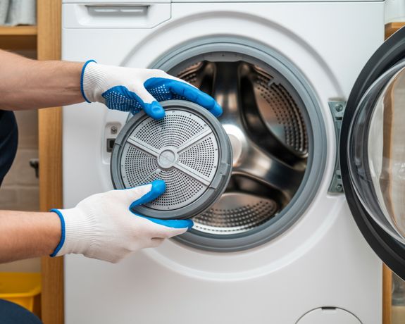 A Person Holding White Front Load Washing Machine