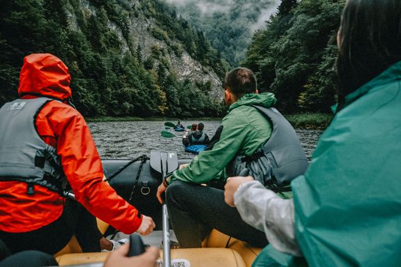 People in Boats Rafting on Mountain River