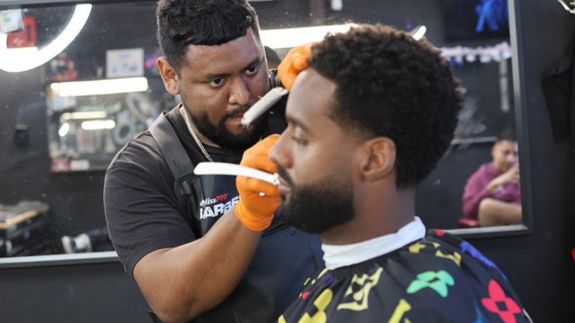 Mirror Reflection of Man Shaving Man's Beard
