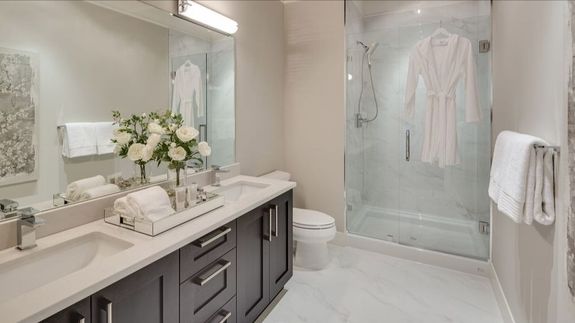 Wooden hanger with towels and basket with bathroom products