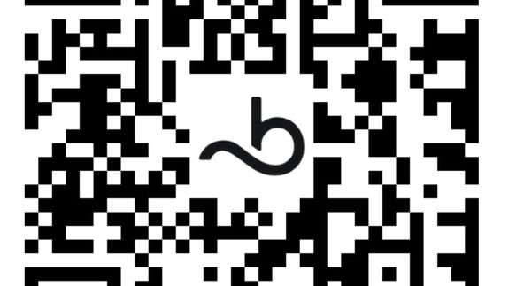 An evening scene of a smartphone on a tripod taking a photo of the sunset over the ocean.