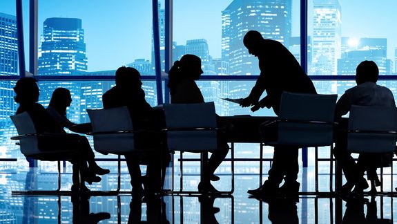 Formal man with tablet giving presentation in office