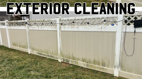 A man is washing the street with a hose