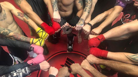 silhouette of person standing on rock surrounded by body of water