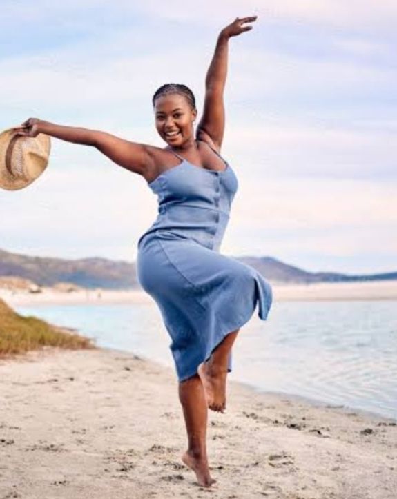 Woman Standing on Cliff