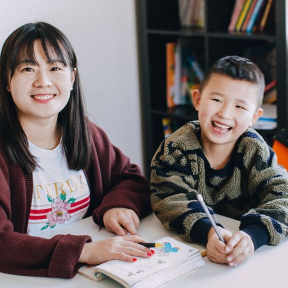girl holding purple and green camera toy