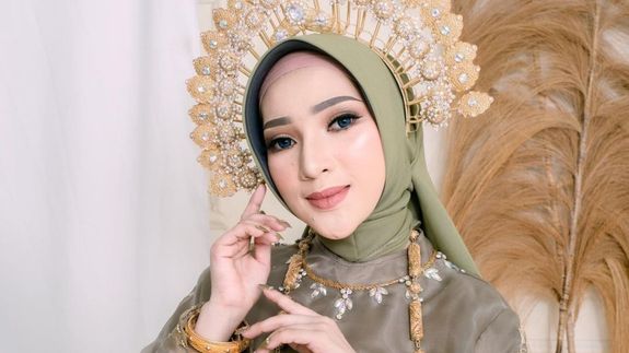 Crop unrecognizable coworkers in formal wear standing at table with laptop and documents while greeting each other before meeting