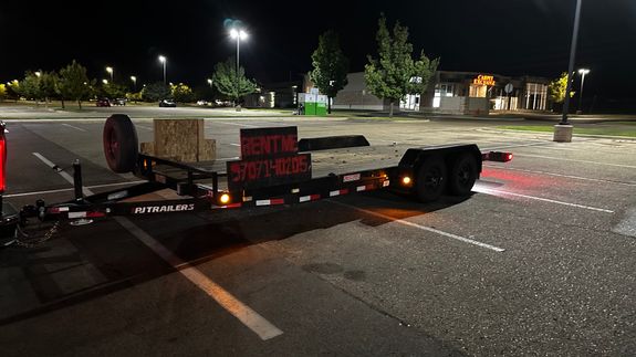 Grey and Black Recreational Vehicle on Ground Under Blue and White Sky