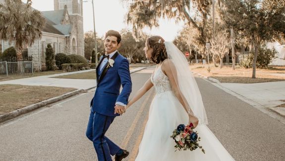 Line of White Flowers-topped Brown Wooden Pillars