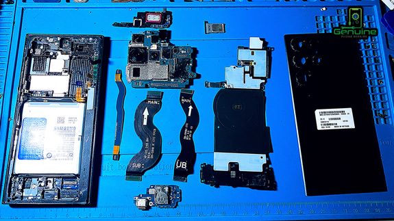 Crop unrecognizable coworkers in formal wear standing at table with laptop and documents while greeting each other before meeting