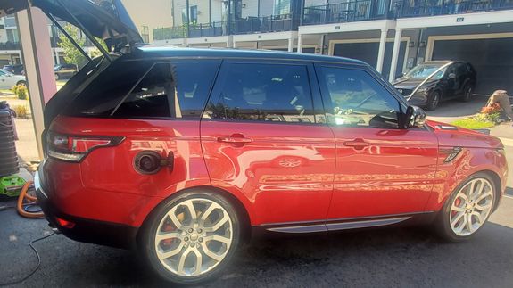 Close-up of a luxury white car highlighting its sleek design and headlight. Ideal for automotive enthusiasts.