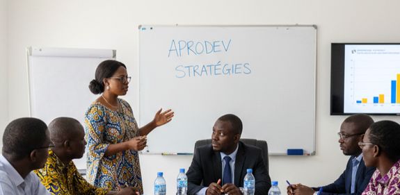 Three professionals collaborate during a business meeting, reviewing documents in a modern office setting.