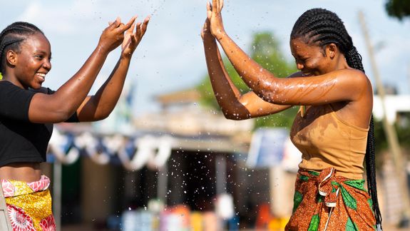 A business conversation between a man and woman in a modern office setting, focusing on engagement and communication.