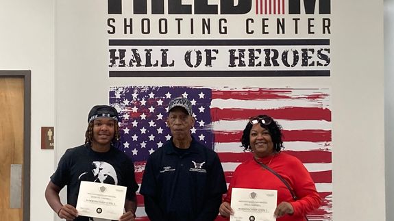 Black Semi Automatic Pistol With Gold and Silver Round Coins