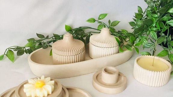 A Person Holding a Lighted Candle in a Container