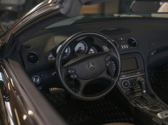 A car interior with a steering wheel and dashboard
