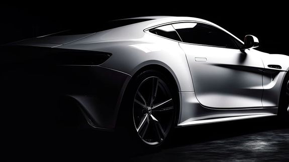 Luxury contemporary automobile with bright indicators parked on asphalt near fresh green grass